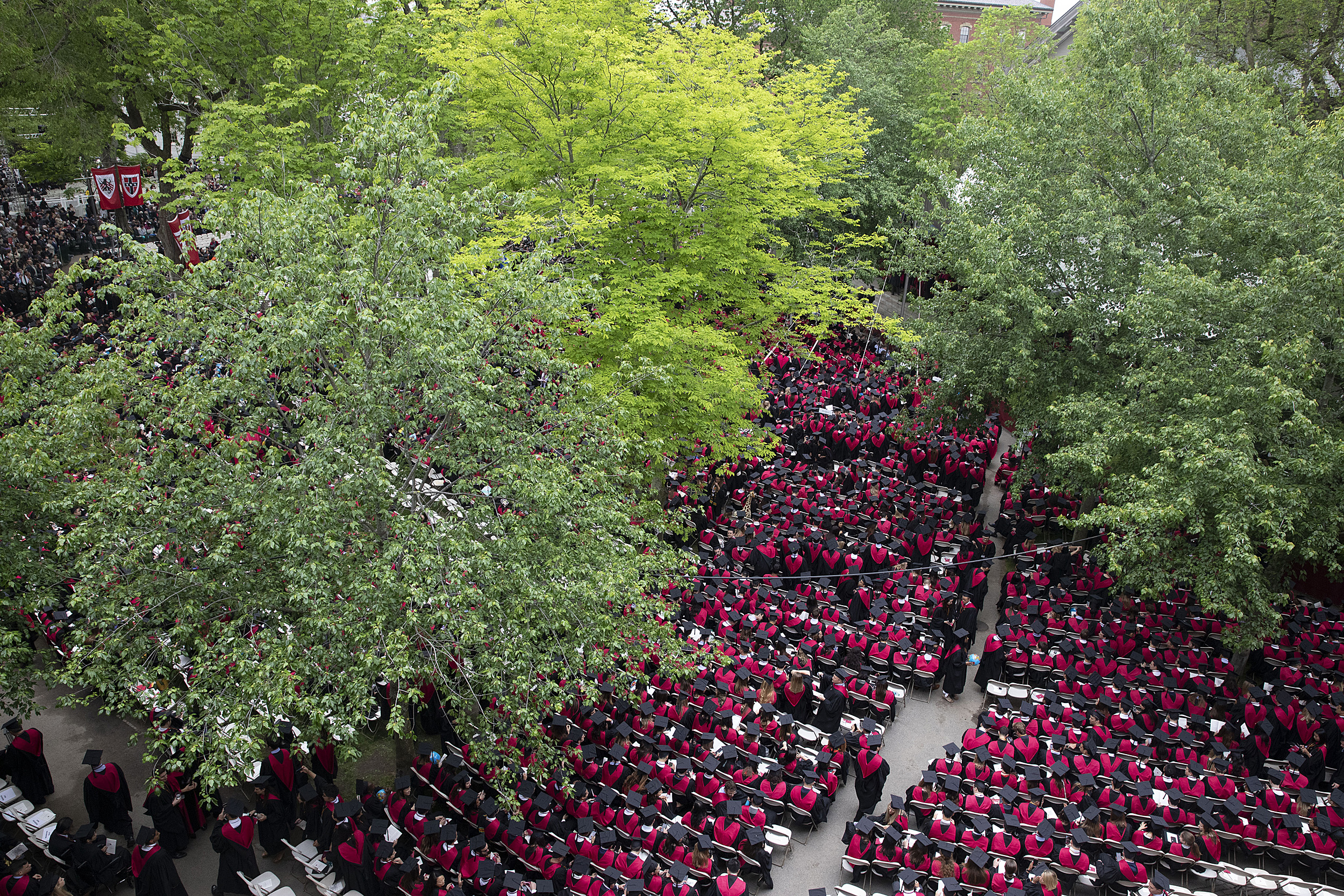 A birds eye view of a sea of Business School Graduates in red robes during Commencement morning exercises