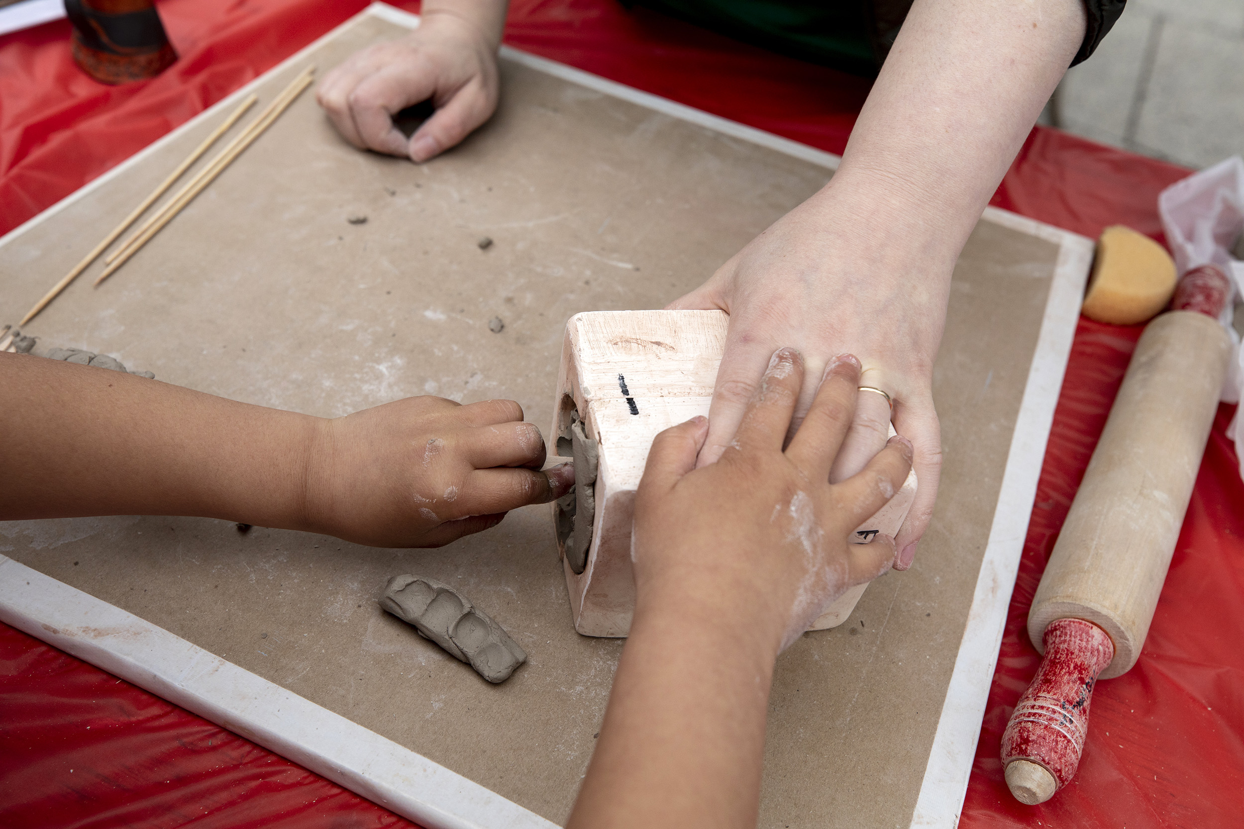 Child presses clay into a mold.