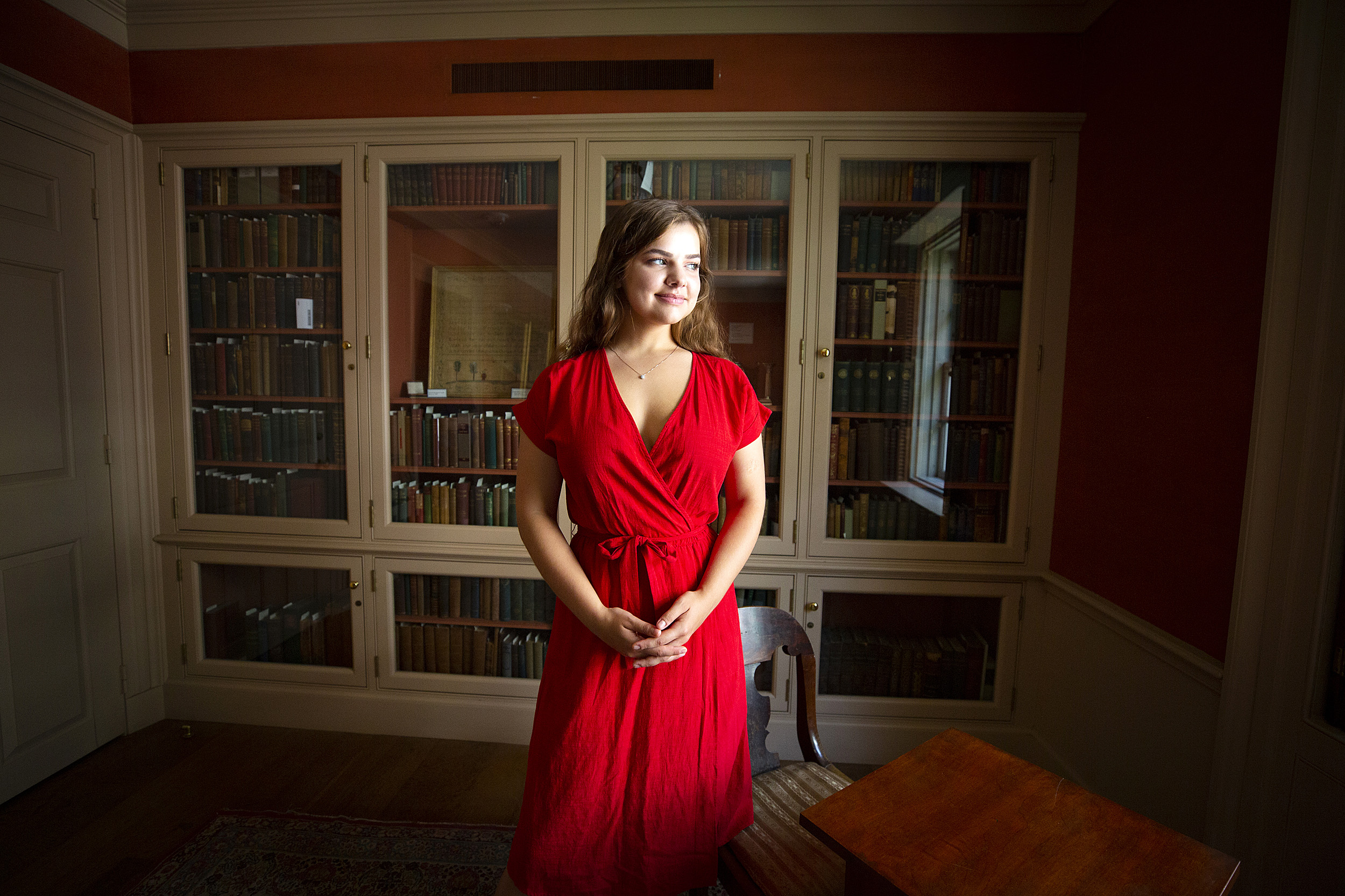student in a red dress in the library