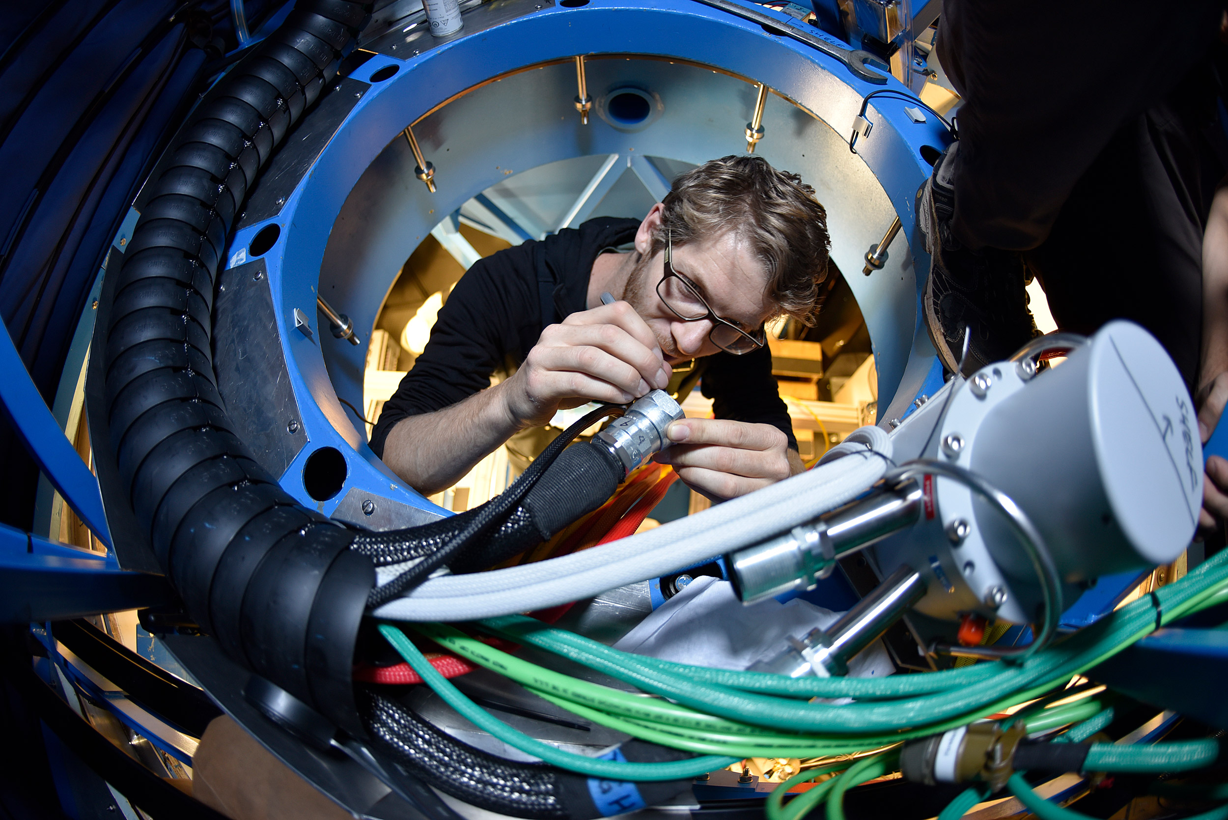 Jamie Tolan cleans cryogenic hoses for the BICEP3 telescope.