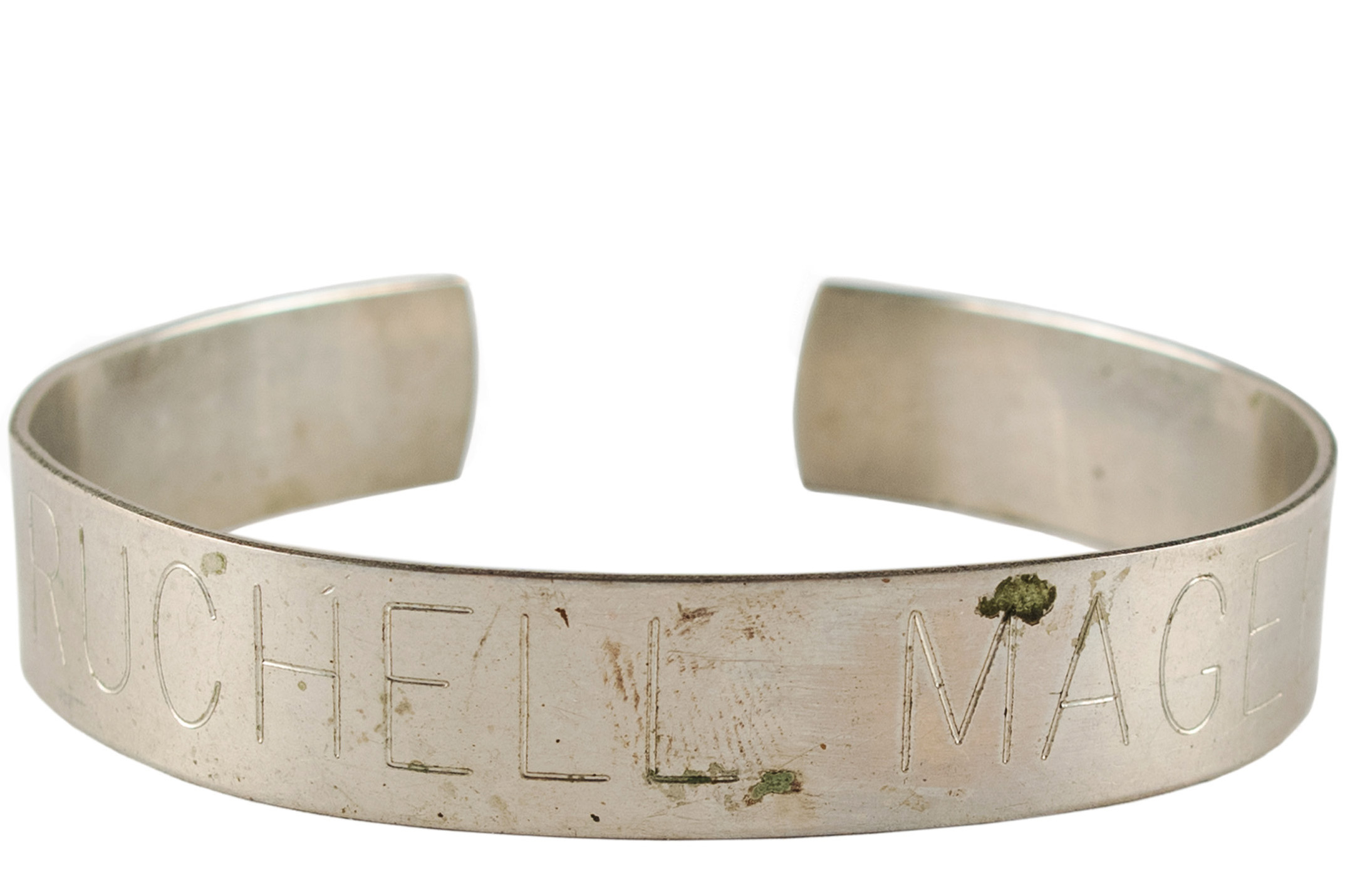 A metal bracelet engraved with the name Ruchell Magee.