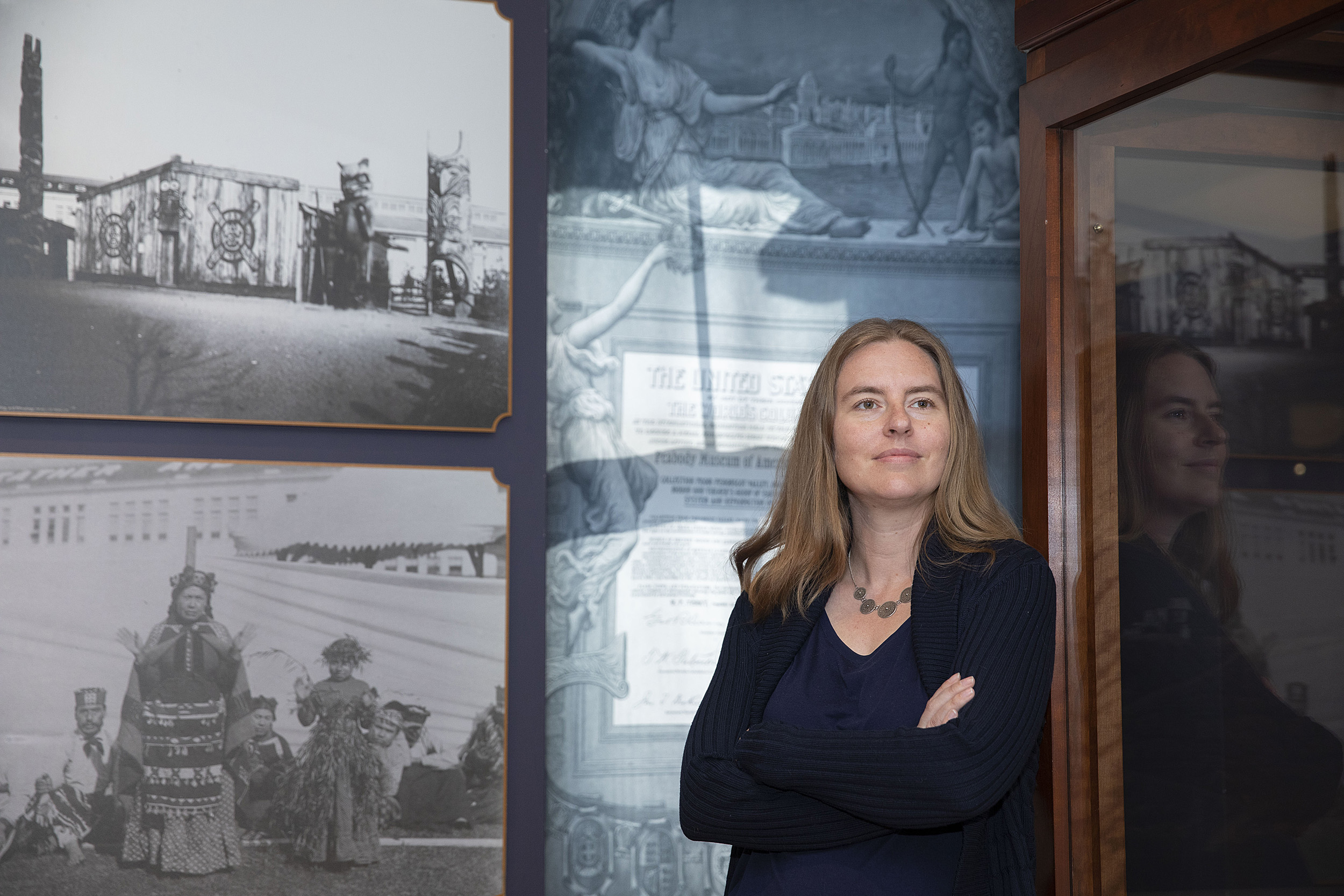 Christina Warinner is a new faculty member photographed in front of a display at the Peabody Museum.