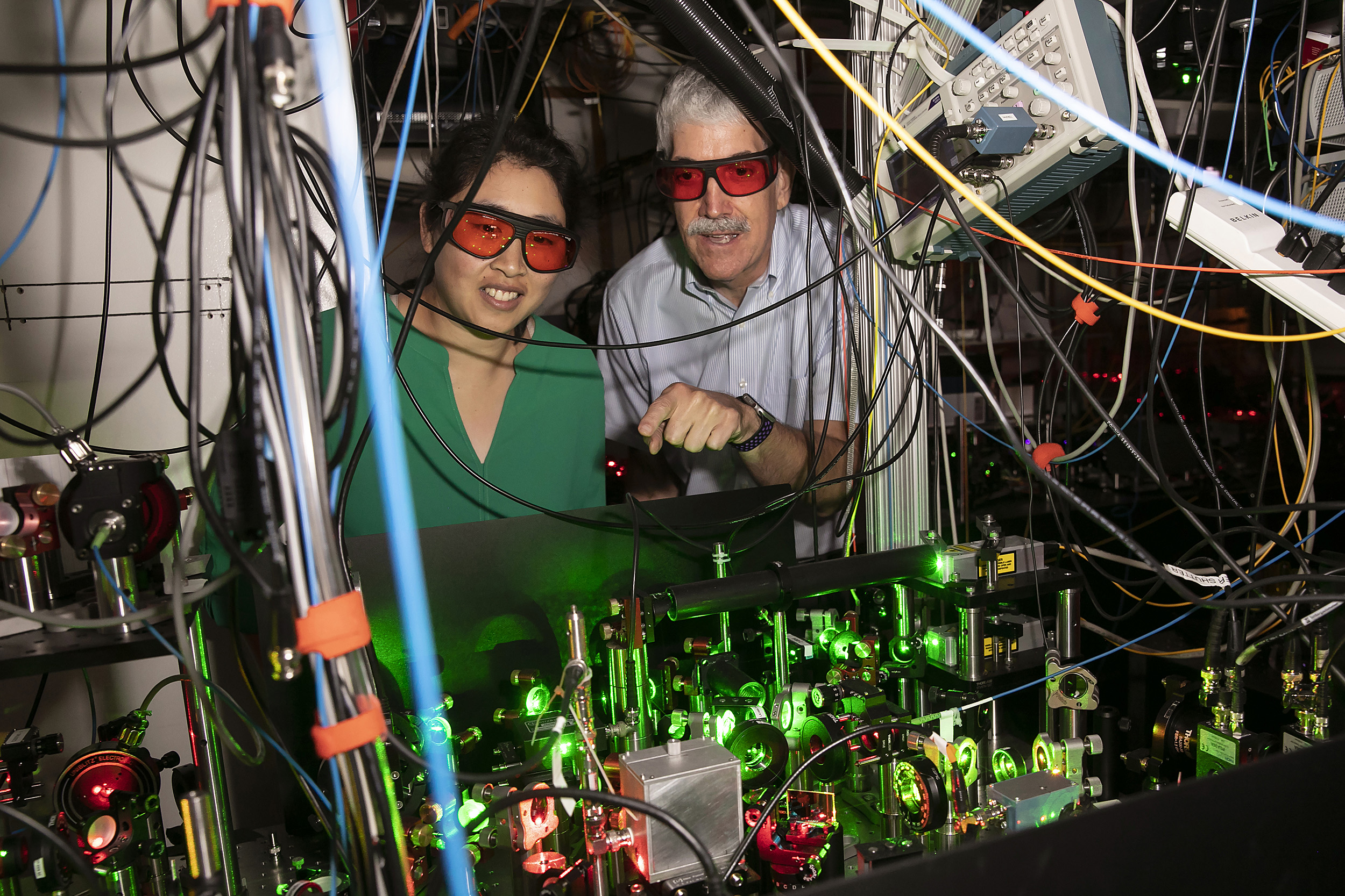 Using precisely focused lasers that act as optical tweezers