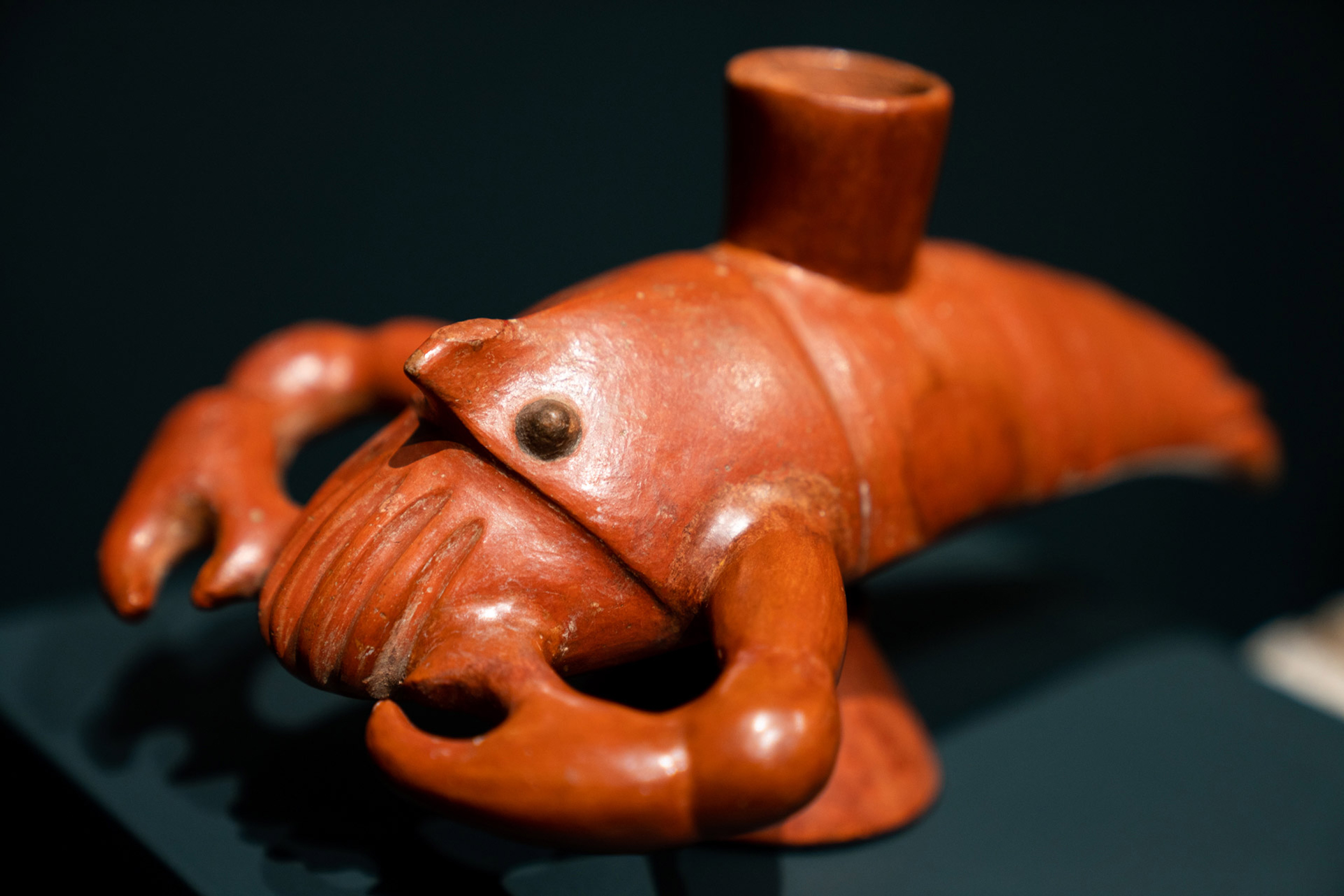 A red crayfish-shaped stirrup cup