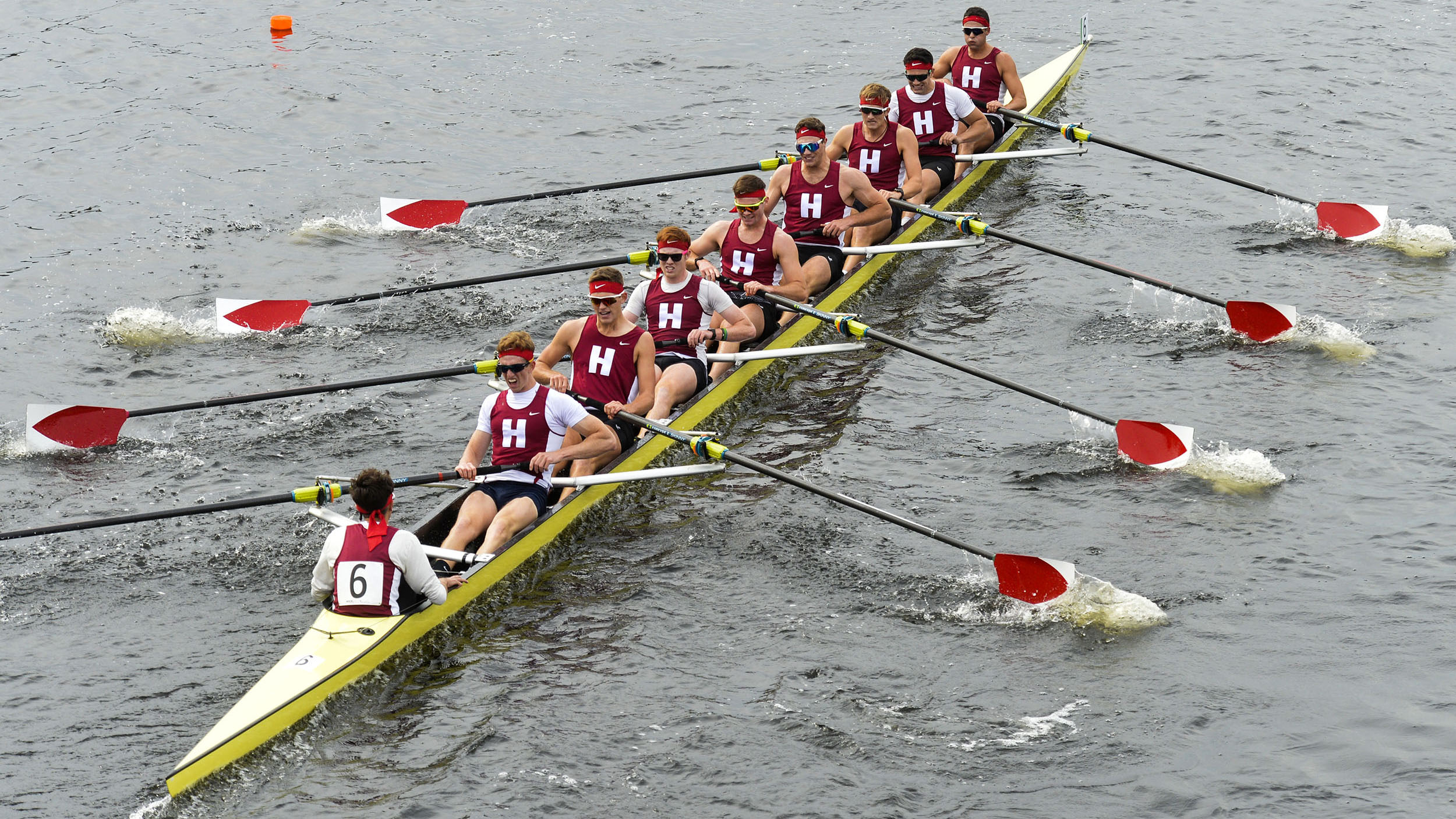 Harvard’s heavyweight boat passes beneath the Weeks Footbridge in the men’s championship eights race during the Head of the Charles.