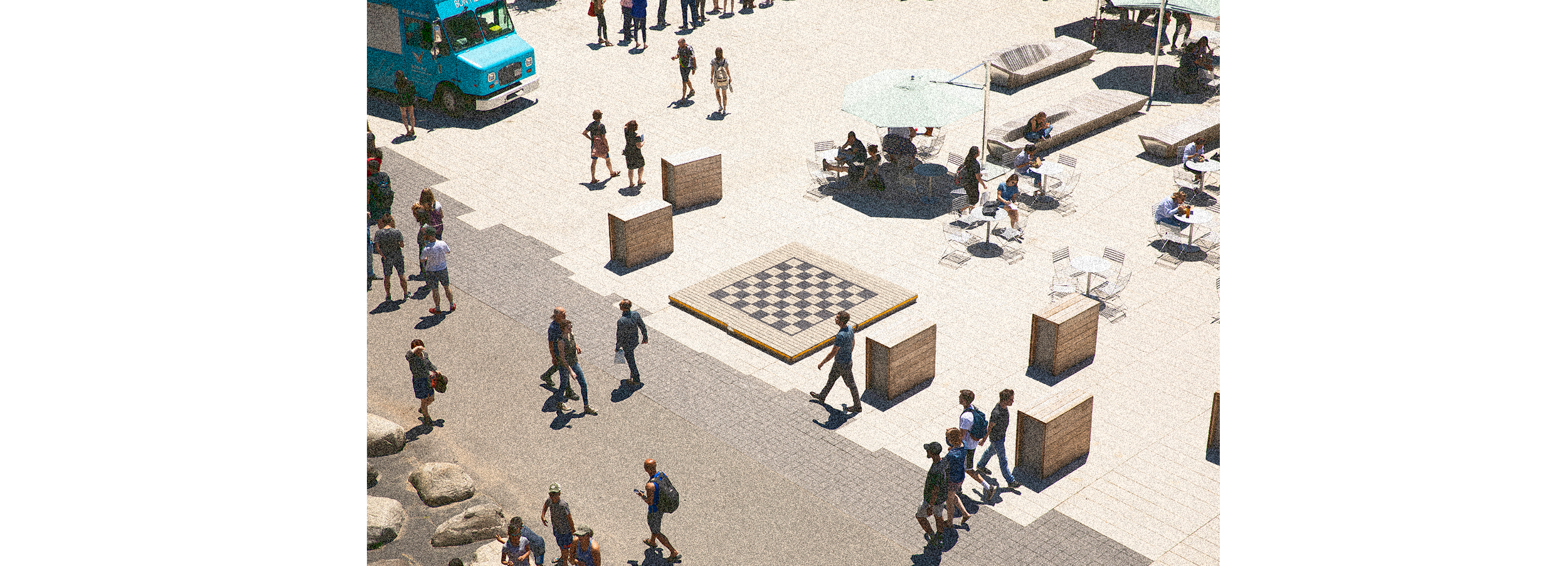 Overview of tables, food truck, passers-by in Science Center Plaza.