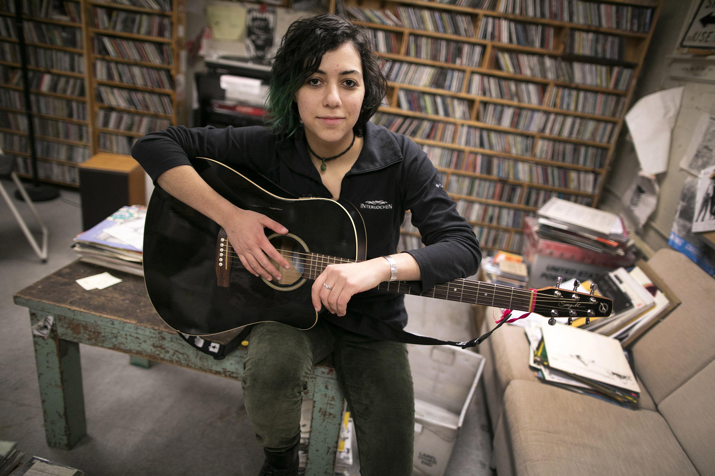 Emily Spector is pictured in the WHRB studio with her guitar.