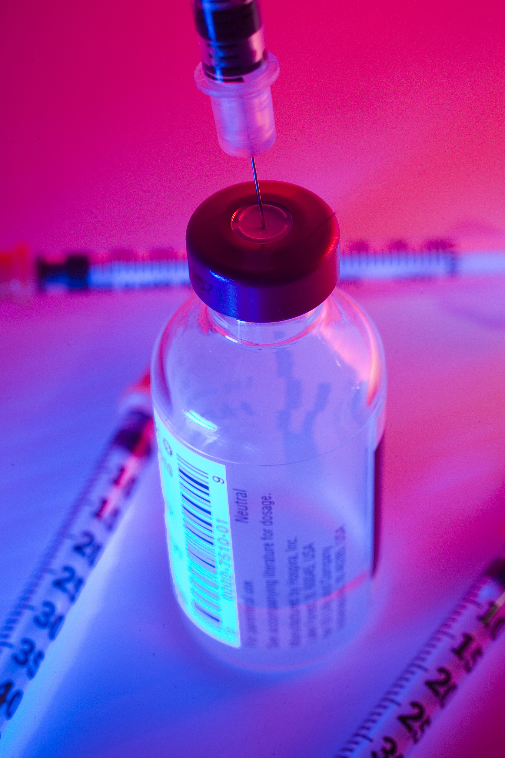Syringe in vaccine bottle.