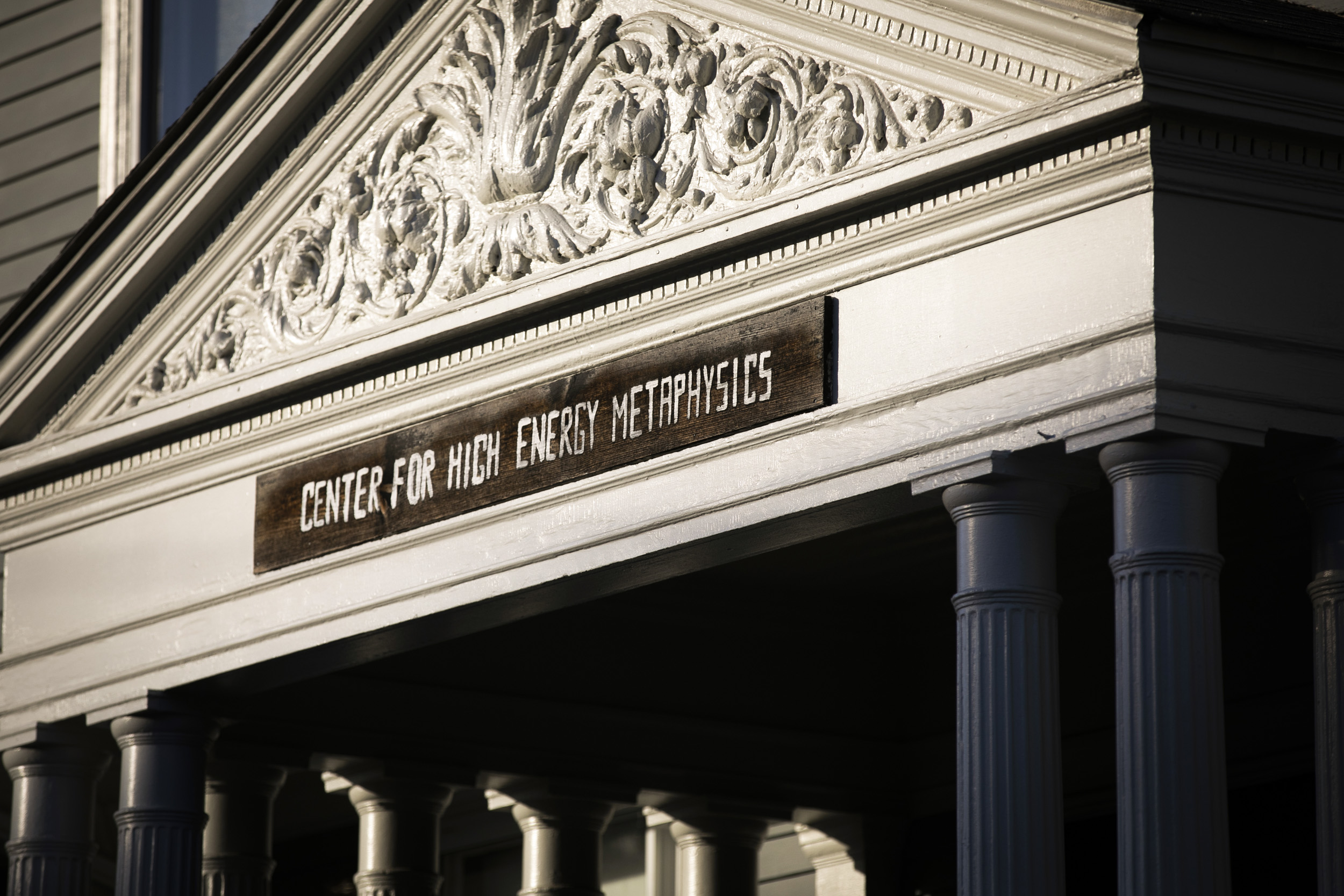 The hand-painted sign above one entrance that reads “Center for High Energy Metaphysics.”