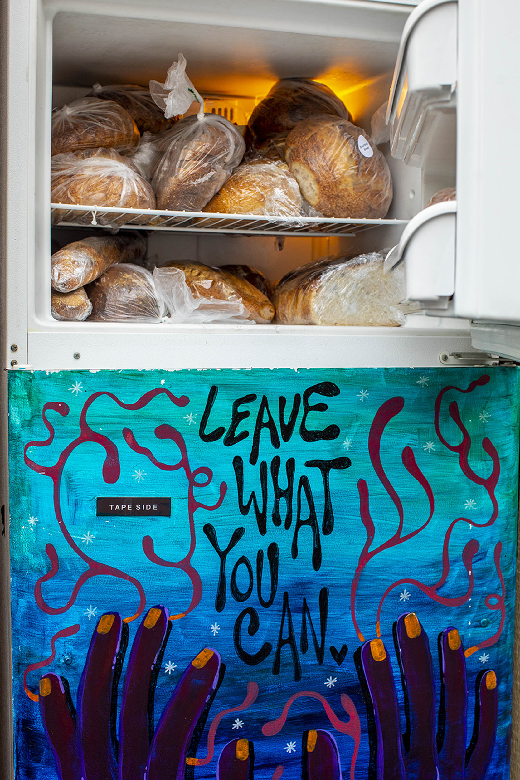 A refrigerator is filled with food as part of a mutual aid organization in Harvard Square.