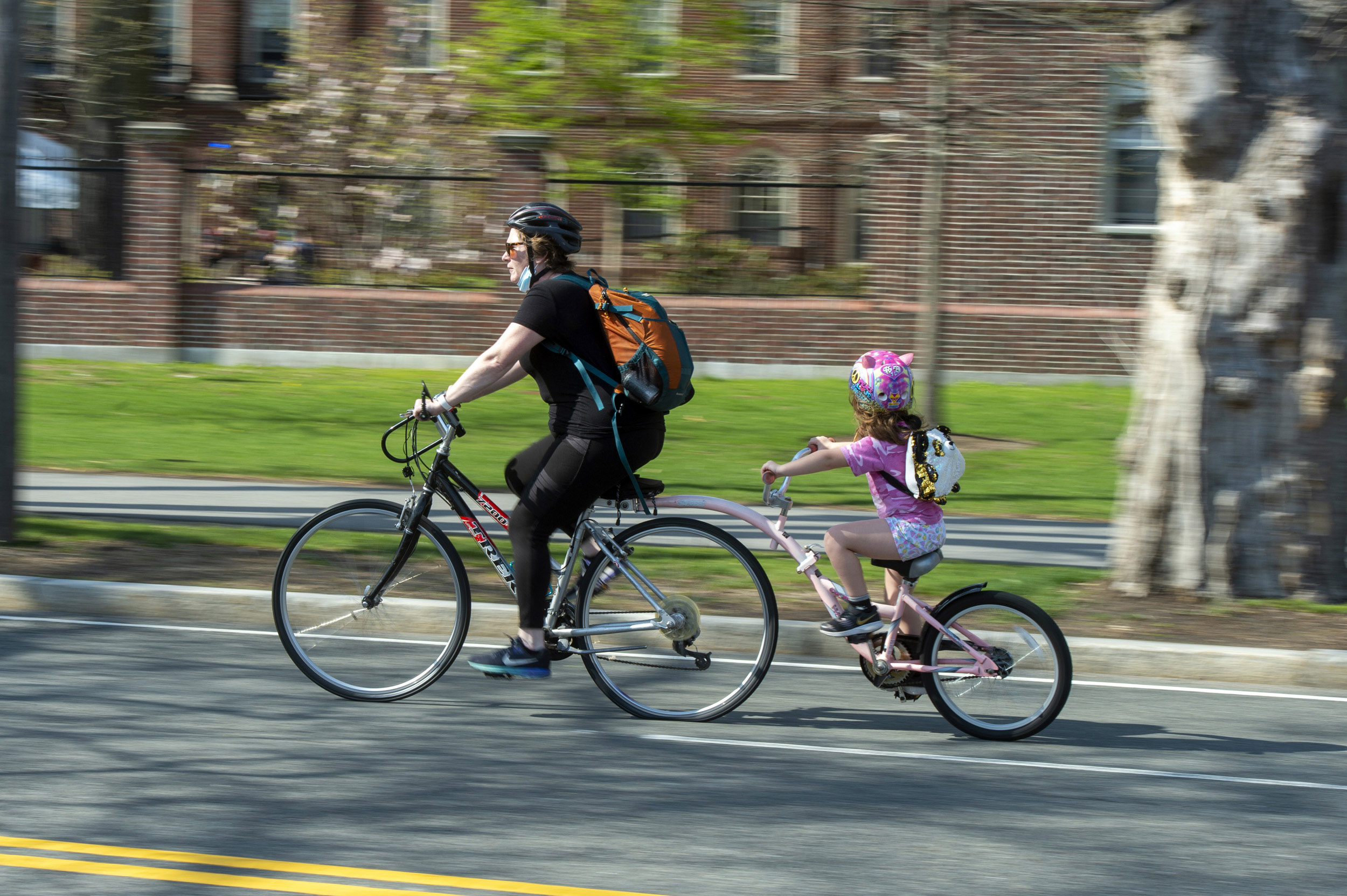 A mother and daughter cruise along the newly closed roadway on Memorial Drive.