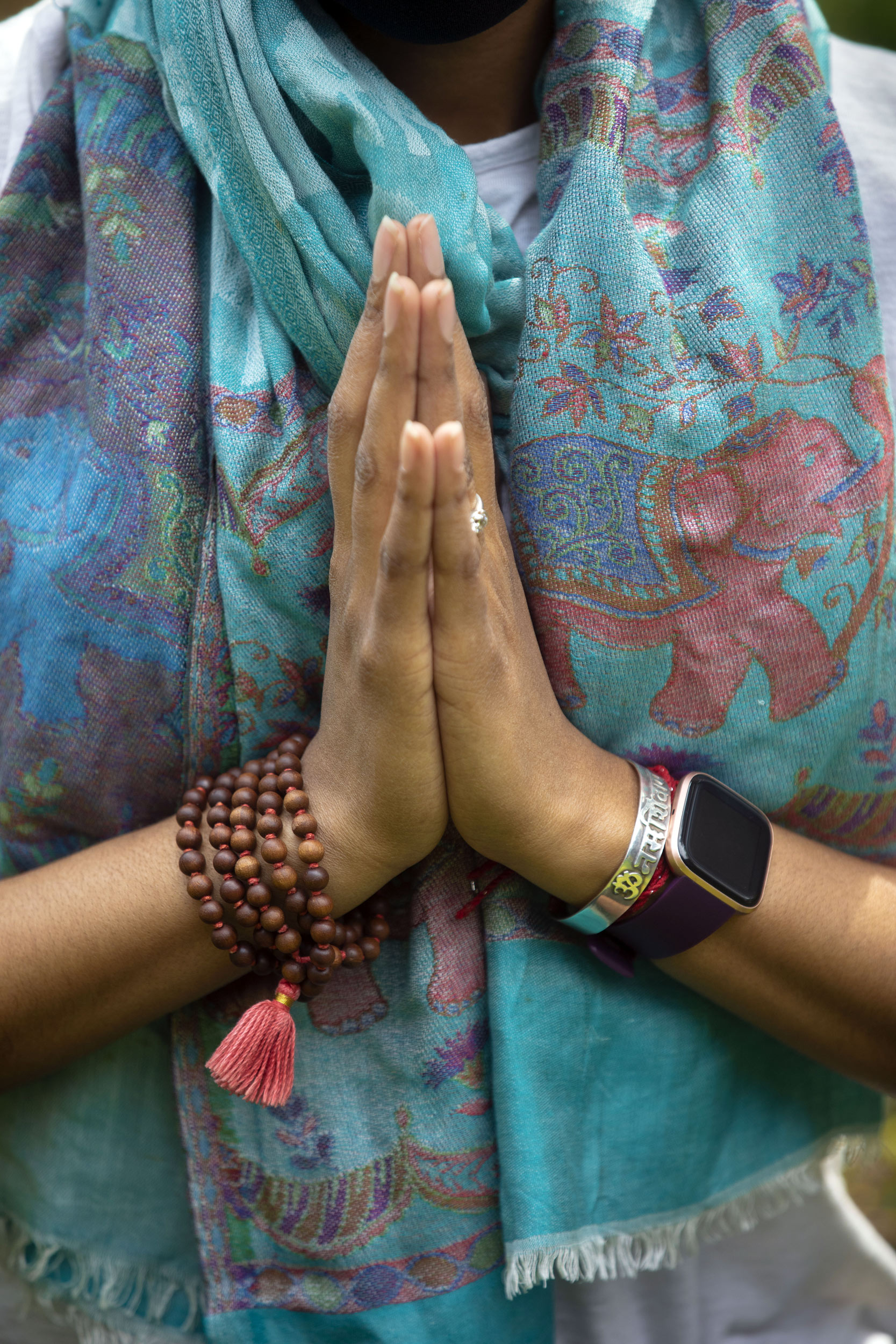 Jessica Chang practices yoga, holding her hands in a prayer.