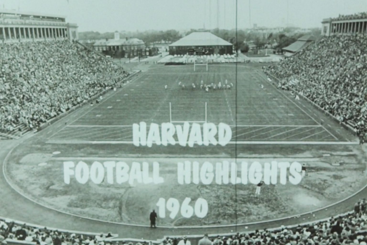 a black and white still of the Harvard stadium.