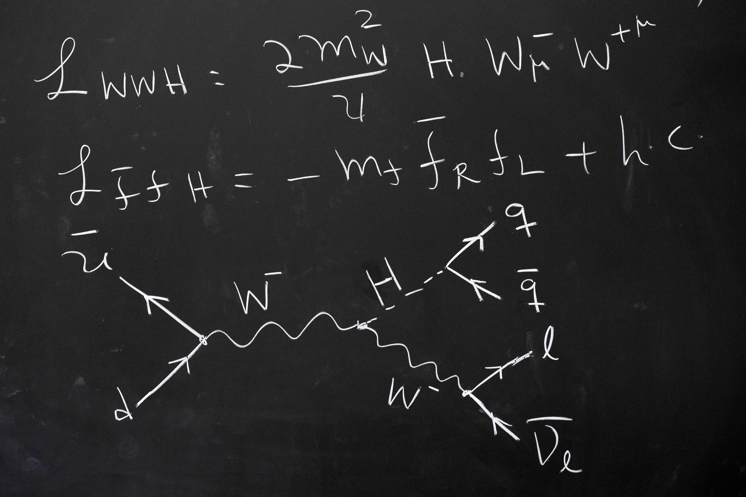 Equations on chalkboard.