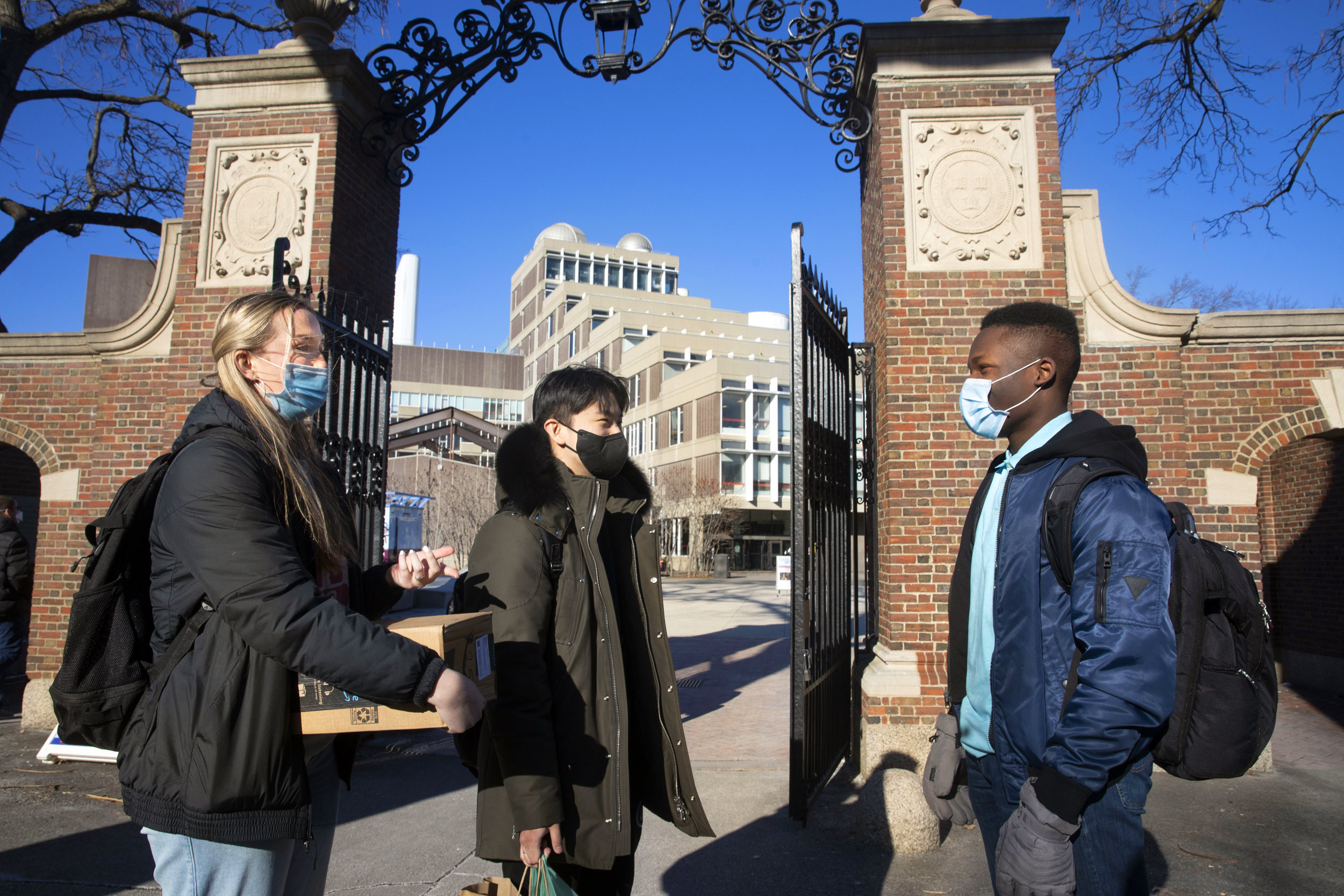 Beneath the Science Center gate, first-years Cara Salsberry (from left), Christian Um, and Ejike Ike chat.