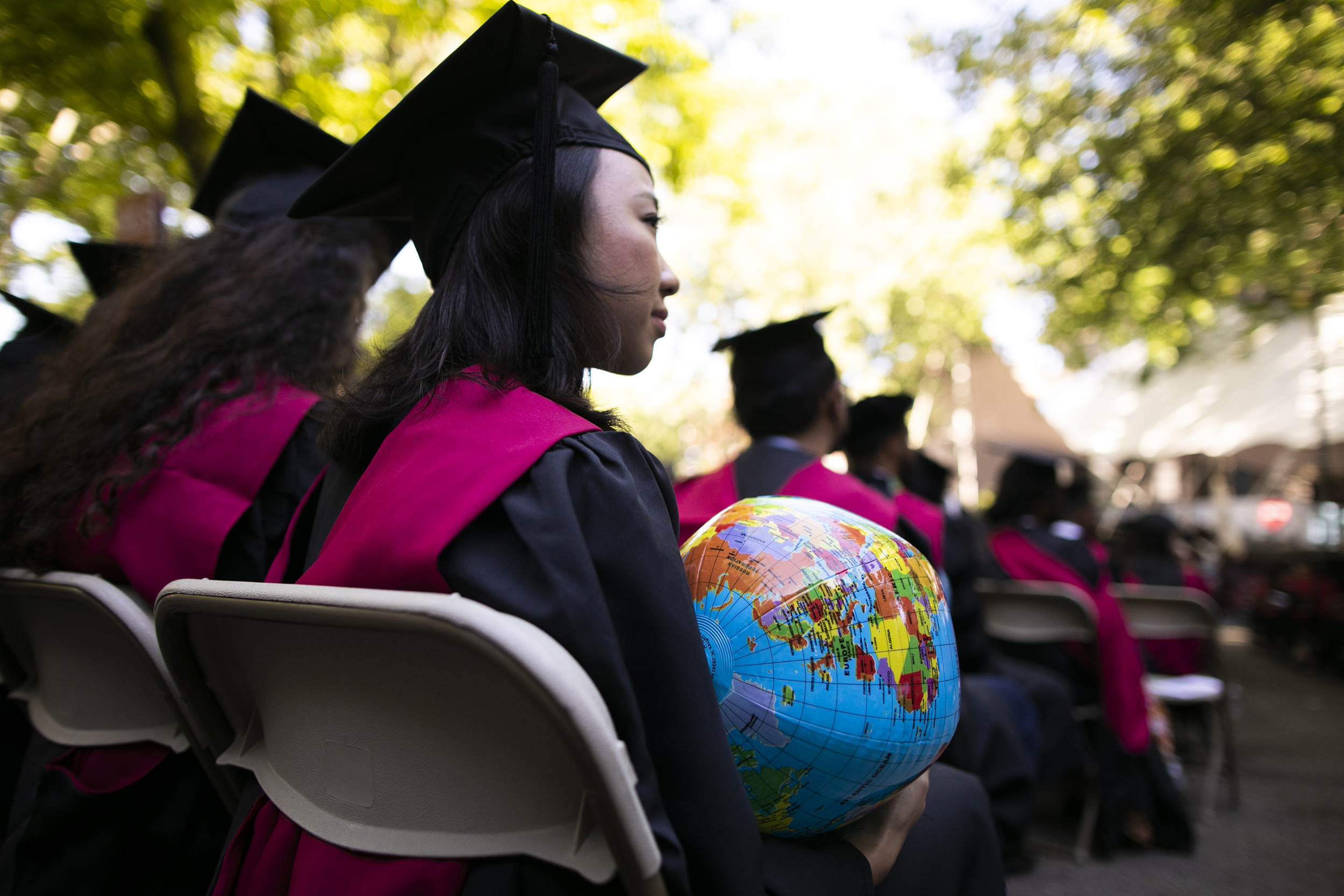 Jane Tjahjono HKS '20 is pictured holding a globe during the ceremony.