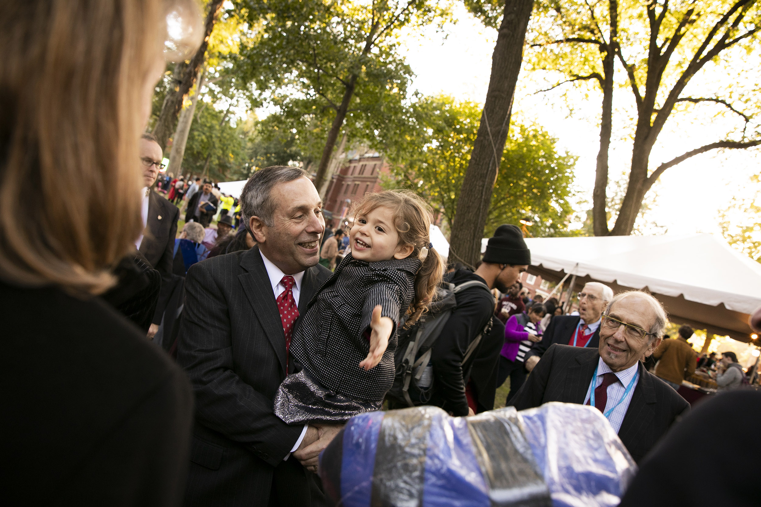 Larry Bacow with granddaughter at his inauguration as Harvard president.