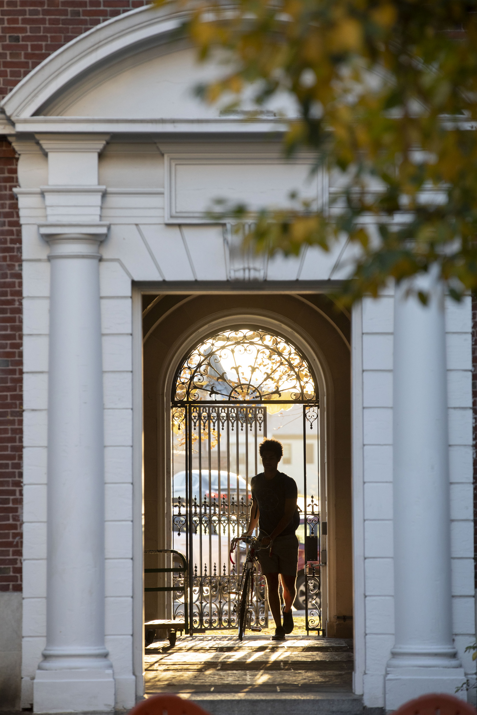 A bicyclist enters the Eliot House courtyard.