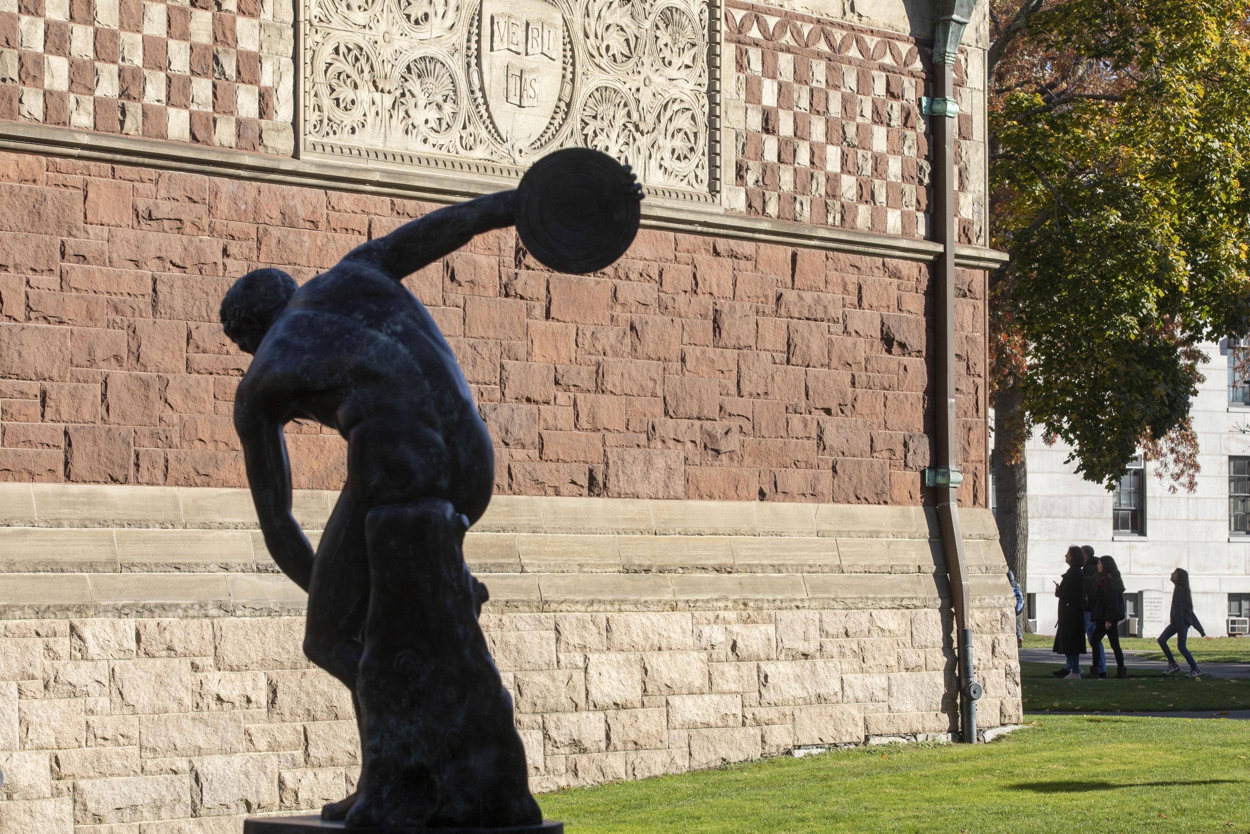 A bronze replica of the Discobolus of Myron is silhouetted on Austin Hall.