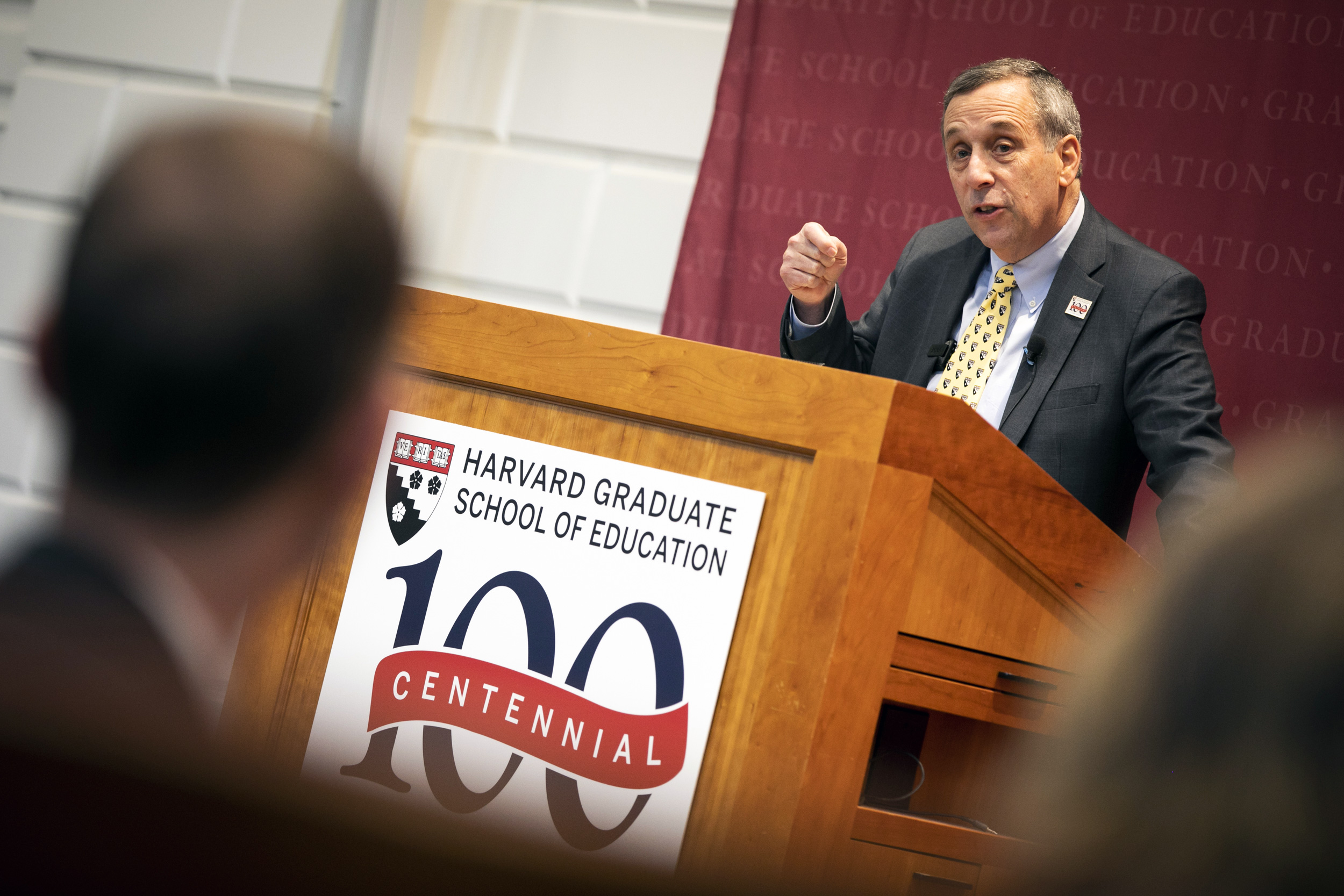 Bacow speaks from the podium when the Graduate School of Education kicked off its centennial celebration in January 2020.