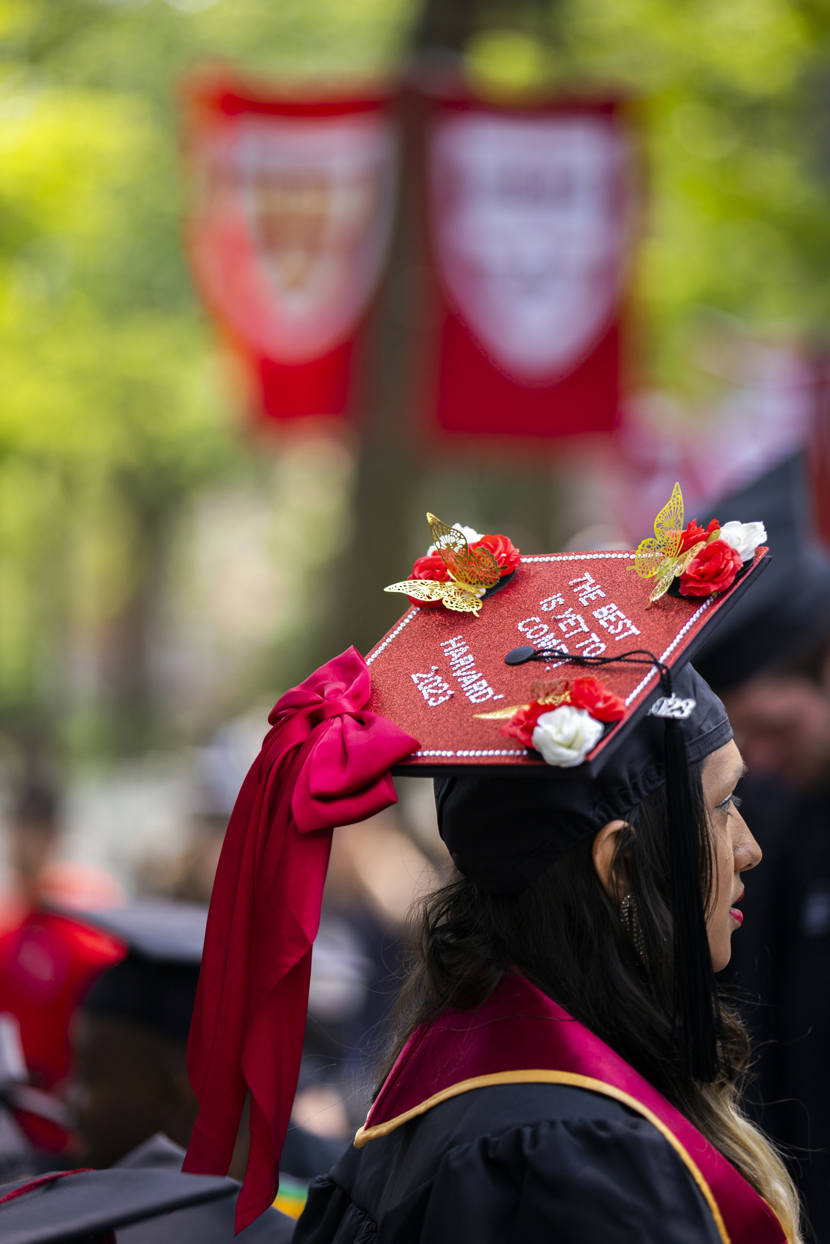 Nisha Sayed wears decorated mortarboard reading "The best is yet to come!"