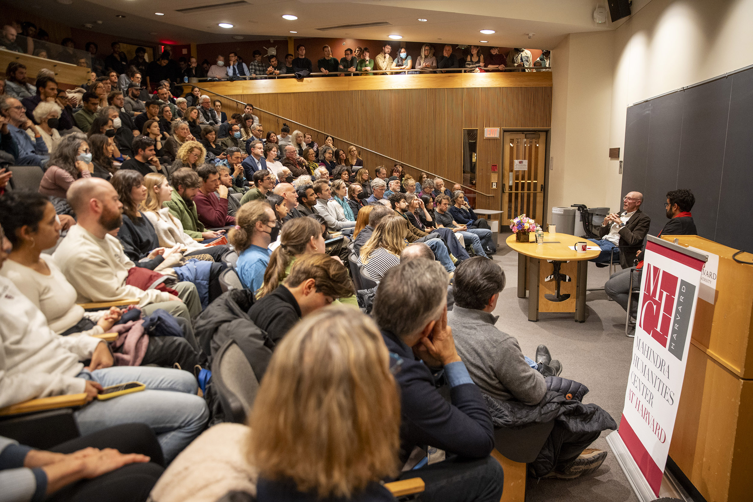 Michael Pollan (left) and Bruno Carvalho speaking in front of a full audience during the event.