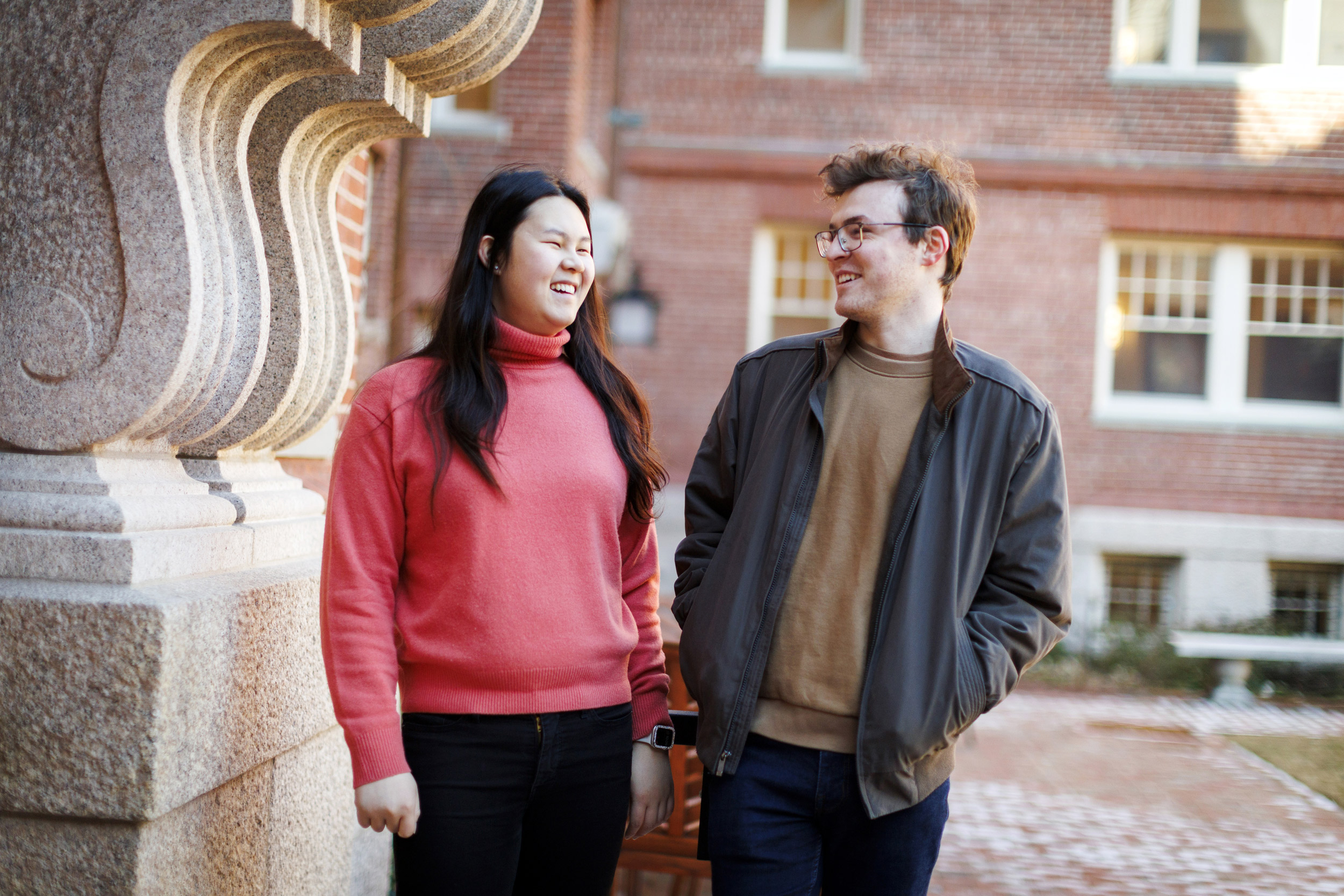 Lily Liu (left) and Tate Underwood share a moment in the Randolph Courtyard, one of their favorite locations at Adams House.