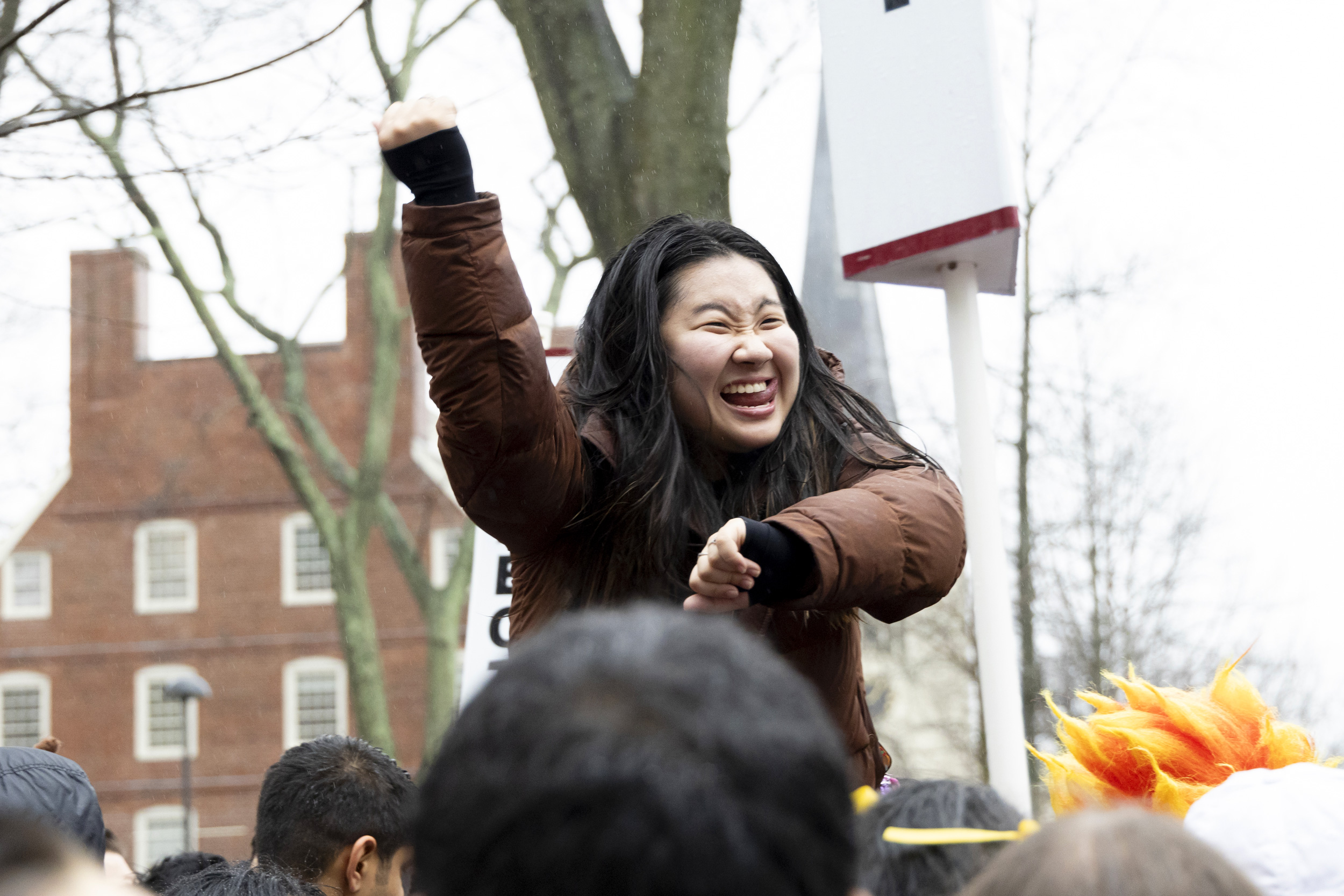A student cheers for Cabot House in Harvard Yard.