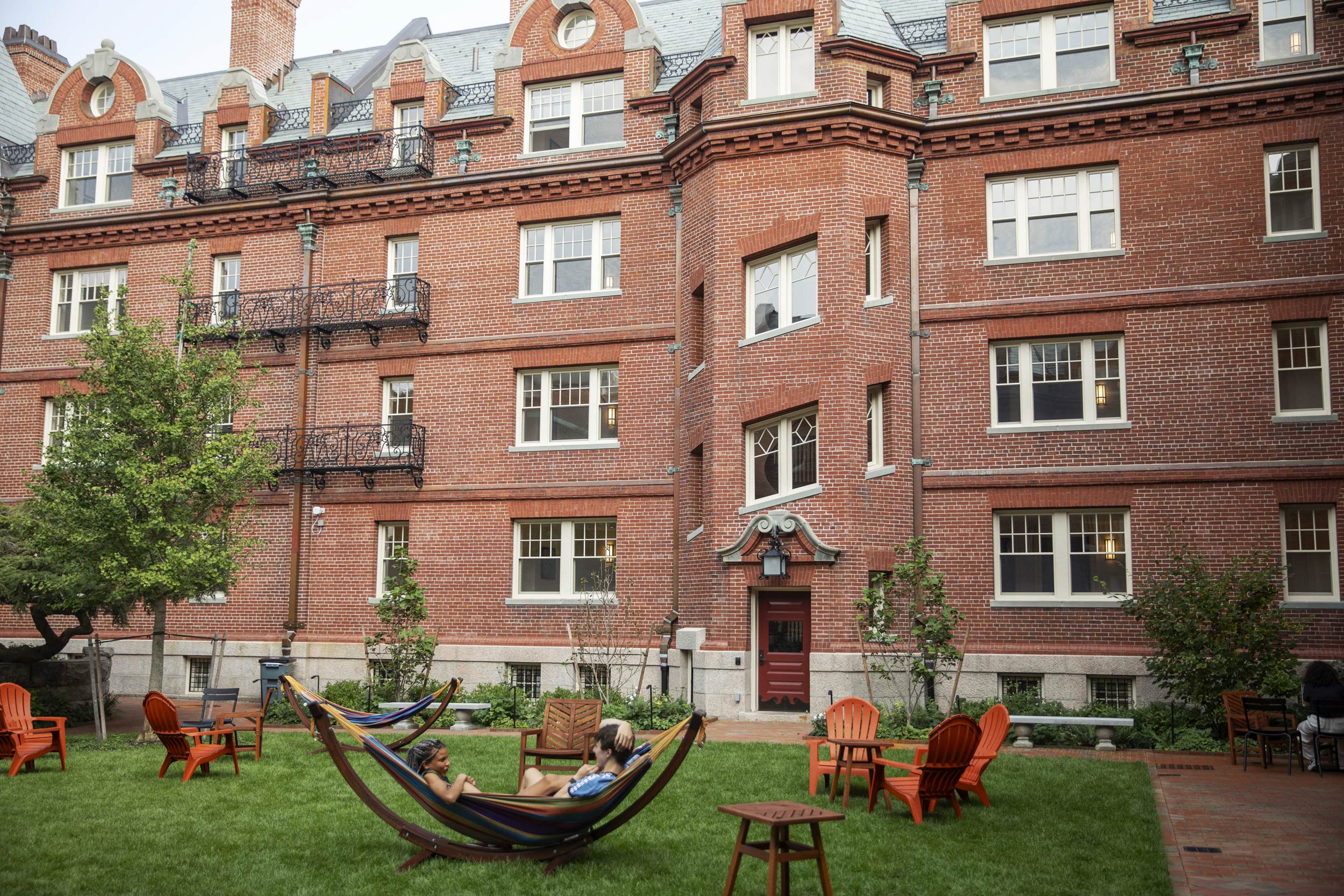 Students enjoy the newly renovated sections of Randolph Hall at Adams House in the courtyard