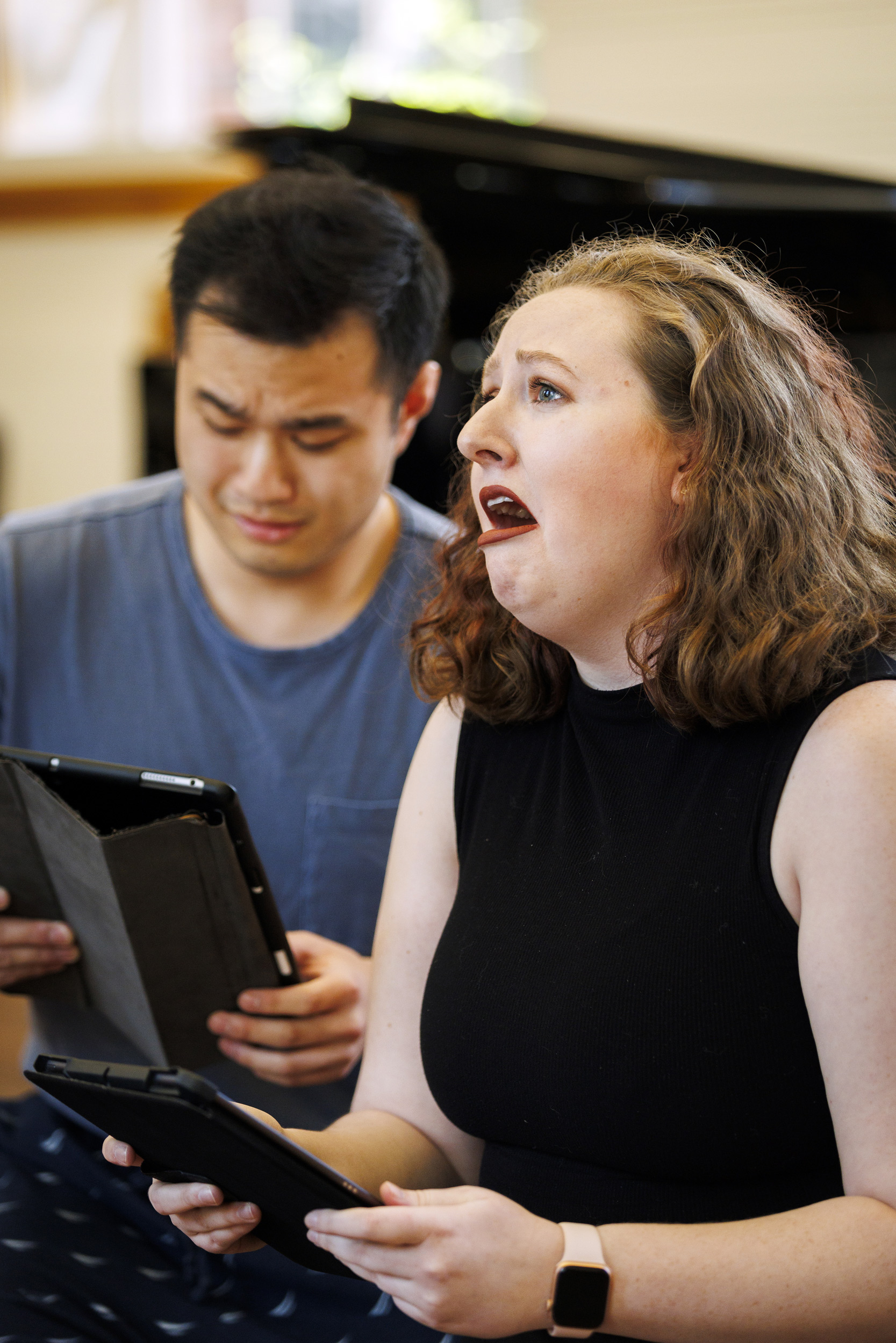 Andrew Lu ’24 (left) and Caitlin Paul ‘24 sing during a performance.