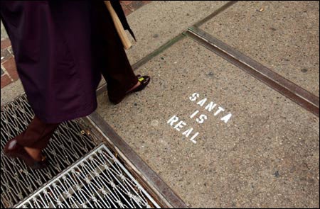 Photo of 'Santa is real' graffiti on sidewalk