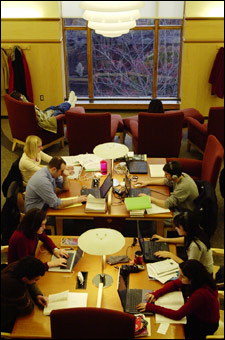 Students poring over laptops in