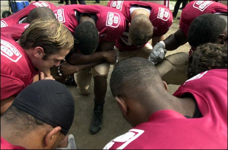The Crimson pray before the game
