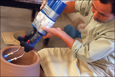 applying blowtorches to a