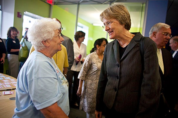 In June, Harvard President Drew Faust (center) and Mayor Thomas M. Menino (background) awarded the first round of Harvard Allston Partnership Grants. Faust chats with Allston resident Rita DiGesse (left) at the summer ceremony. Applications are now being accepted for the second round of grants. 