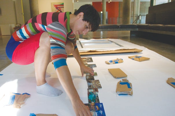 Carlin Wing '02 assembles her exhibit at the Carpenter Center.