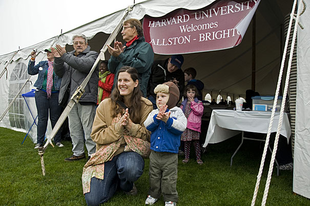 Birgit Swain and 22-month-old Elliot Swain of Brighton applaud the Harvard Band during the Allston-Brighton pre-game festivities. 