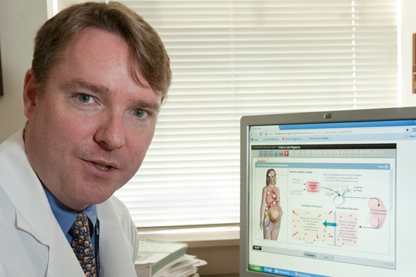 John Ross, a Brigham physician and HMS instructor, shows the new online interactive interface that allows doctors to order tests, examine results, and answer questions on where to delve next.
