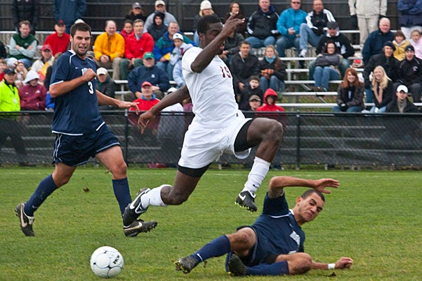 Kwaku Nyamekye '10 (center) takes the high road over a competitor as the Harvard men’s soccer team scores twice in the second half to defeat Monmouth, 3-0.