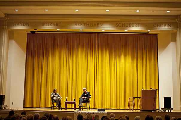 Former New York Times reporter Linda Greenhouse, now a member of Harvard’s Board of Overseers (left), moderates a talk with President Drew Faust (right) before an audience of Harvard alumni at Paine Hall.