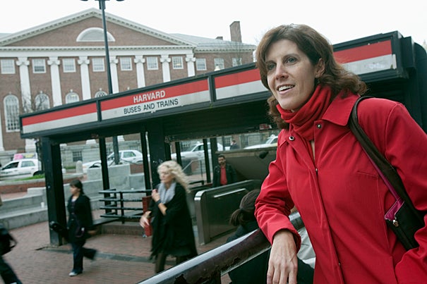 Locke, seen here by the Harvard Square T station, is a transportation maven, overseeing the diverse ways in which the Harvard community commutes.