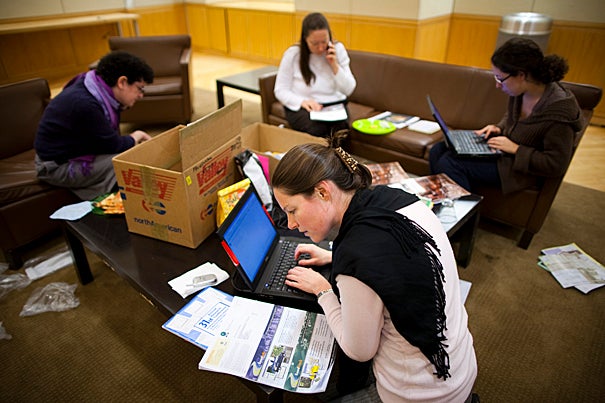 Volunteers from the Office for Sustainability collect unwanted mail in collection areas around the campus. 
Eco-citizens Sage Kochavi (clockwise from left), Montana Higo, Dara Olmsted, and Claire Reardon participate in a “junk mail party” to unsubscribe people from companies’ mailing lists.