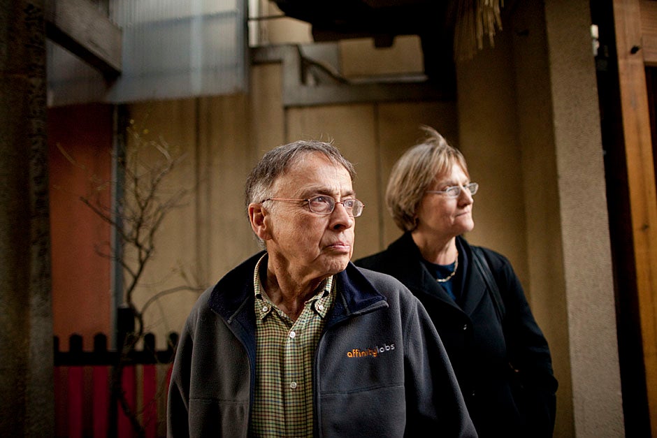 Charles Rosenberg and Drew Faust stroll through a marketplace. 
Stephanie Mitchell/Harvard Staff Photographer