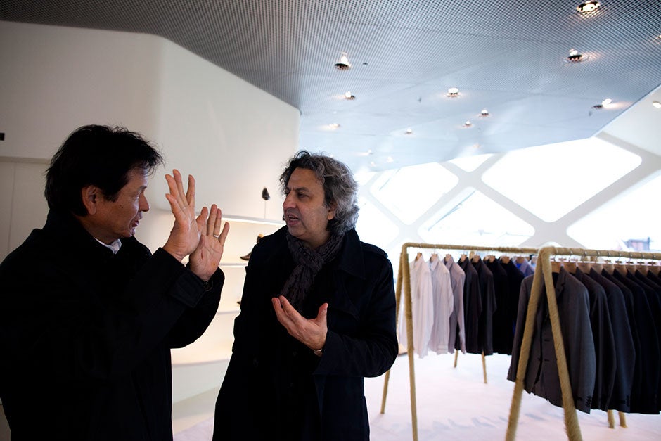 Faust tours the architectural sights of Tokyo, including the Louis  
Vuitton, Tod's, and Prada buildings, with Harvard Design School Dean Mohsen Mostafavi. Here, Makoto Hoshino (from left) and Mostafavi discuss the design of the Prada building. Stephanie Mitchell/Harvard Staff Photographer