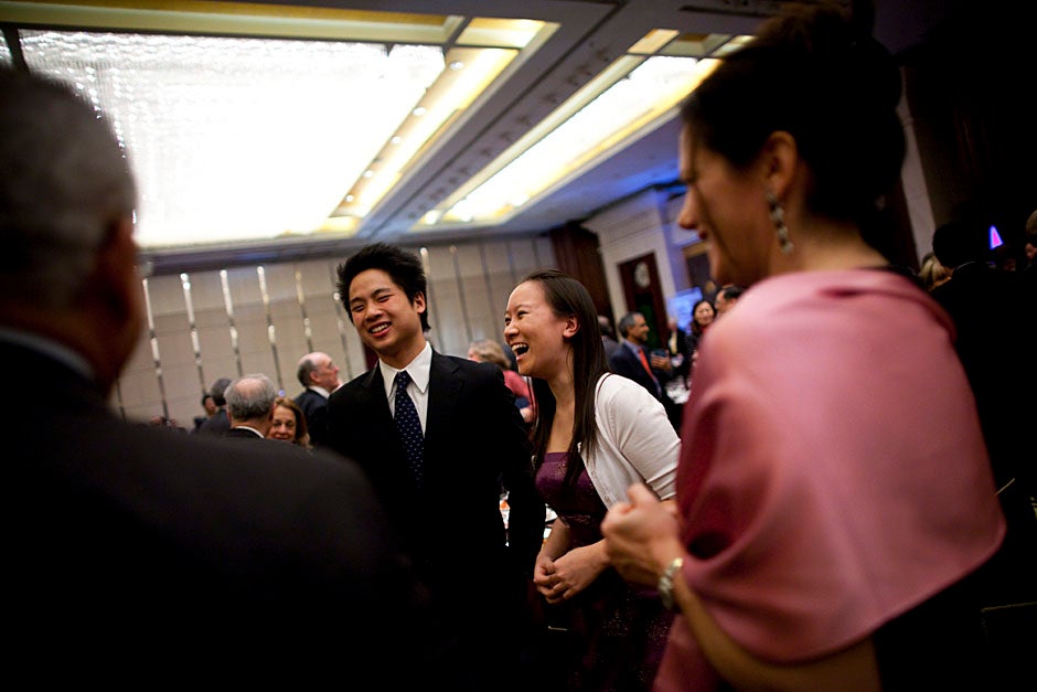 Phillip Zhang '12 (left) and Yi Cai '11 speak with guests following the duet they performed during the banquet. 
Stephanie Mitchell/Harvard Staff Photographer