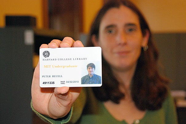HCL assistant head of library billing and privileges Ann-Marie Costa displays a sample library pass, which will give MIT undergraduates access to HCL libraries.