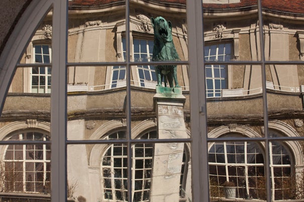 Views of a lion statue reflected in mirrored windows at the Center for European Studies.