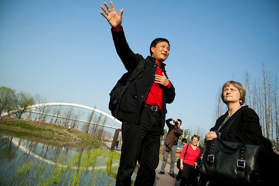 Faust tours the architectural sights of Shanghai, including the World Expo site. Kongjian Yu (from left) speaks with Faust as he leads the walking tour along the World Expo site. Stephanie Mitchell/Harvard Staff Photographer