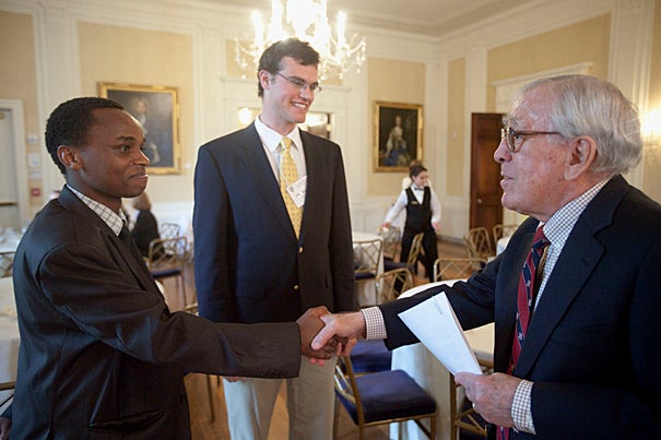 David Mbau '13 (left), who will be interning in Johannesburg, and Elihu Reynolds '12, who will intern in London, meet with Paul Weissman ’52 during the spring luncheon.