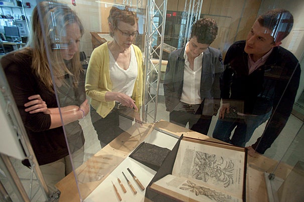 The exhibit “Paper Worlds: Printing Knowledge in Early Modern Europe” was the product of a graduate student seminar. It involved conducting background research, searching Harvard’s various museum collections for appropriate material, designing and building the exhibit itself, and even creating a 100-page catalog and accompanying Web material. Working on the project were graduate student Stephanie Dick (from left), Professor Katharine Park, curator Susan Dackerman, and graduate student Adam Jasienski.